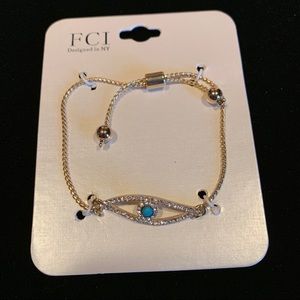 Golden evil eye bracelet with blue stone